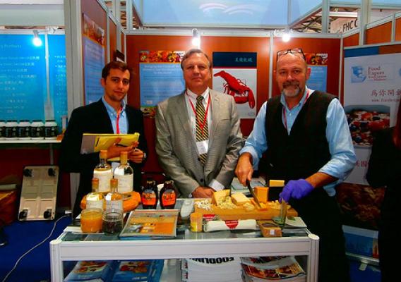 Alex Weiss from Caledonia Spirits, Arnold Coombs from Bascom Family Farms, and Jeremy Stephenson from the Vermont Cheese Council, attend the Food and Hotel China Show in Shanghai to exhibit their agricultural products. The small businesses attended the trade show with the help of one of the State and Regional Trade Groups – coalitions of state departments of agriculture – that use USDA market development program funds to provide support for about 30,000 companies annually. (Courtesy Photo)