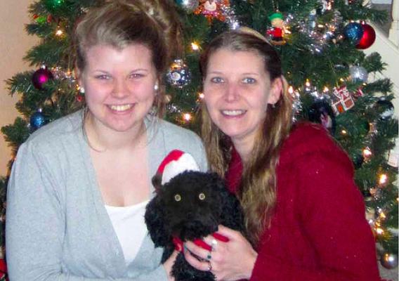 Misty Allen (right), her daughter Deanna and puppy Odysseus are ready for family and friends to share the holidays in their new home. (USDA photo)