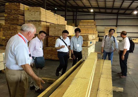 A delegation of Thai lumber company executives (including Opas Panitchewakul, Pracha Thawornjira, Jaroonsak Cheewatammanon, Khomwit Boonthamrongkit and Wasant Sonchaiwanich) tours the Mauvila Timber distribution warehouse in Loxly, Ala., with Lane Merchant (left), the company’s general manager.