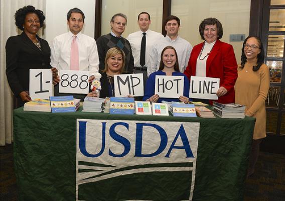 USDA Food Safety Education staff showing the Meat and Poultry Hotline number