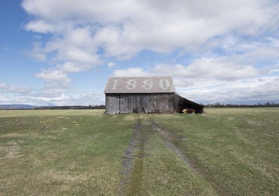 An old barn with the number 1880 on the roof