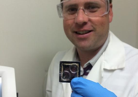 Forest Service Research Botanist Jonathan Palmer holding a DNA sequencing chip