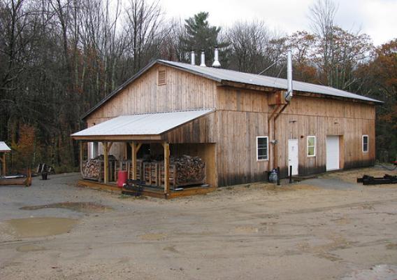 Harvard Forest staff renovated a pole barn to house the boiler room and modern wood shop. The new boiler room (left side of the building) contains three wood gasification boilers, a 2,500-gallon thermal storage tank, a propane-fired backup boiler and associated pumps and system controls. The sloped roof on the left of the building provides a dry storage area for racks of firewood prior to loading in the boilers. (U.S. Forest Service/Rob Clark)