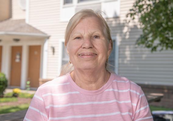 Carole Fosbaugh, a tenant living in a USDA-financed apartment, smiling at the camera